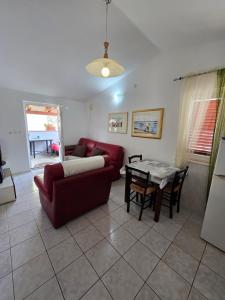 a living room with a couch and a table at Apartmani Nika in Tribunj