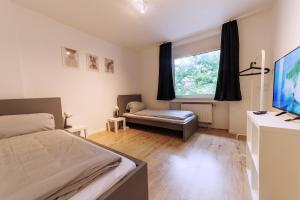 Postel nebo postele na pokoji v ubytování Workerslodge - Wohnung für 6 P in Krefeld