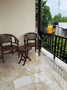 two chairs and a table on a balcony at Perela Homestay Canggu in Canggu