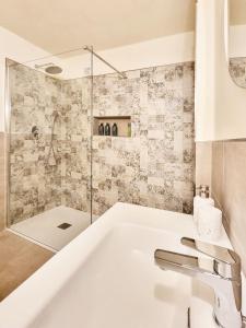 a white bathroom with a sink and a shower at Ai Parlenti 23 - day&night in Tirano +24 photos