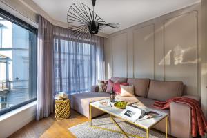 a living room with a couch and a table at Modern View of Planty Park in Kraków