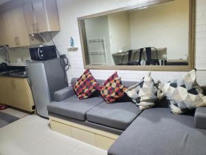 a couch with pillows on it in a kitchen at La Luz - SMDC Breeze Residences in Manila