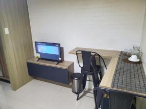a room with a desk with a laptop computer on it at La Luz - SMDC Breeze Residences in Manila