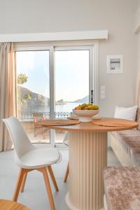 a room with a table with a bowl of fruit on it at Skalia Mountain & Sea Suites in Skaliá