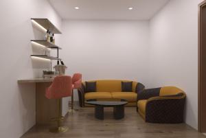 a living room with two chairs and a table at Playotel Grande Rau Indore in Jāmb