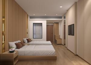 a bedroom with two beds and a flat screen tv at Playotel Grande Rau Indore in Jāmb