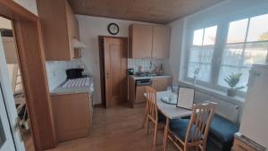 a small kitchen with a table and chairs and a kitchen with a table at FeWo Ehmann- Studio in Frauenkirchen