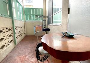 a room with a wooden table and two chairs at Guest house Icyaribacyoude - Vacation STAY 09894v in Naha