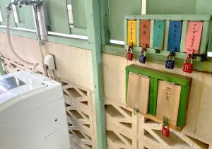 a bathroom with a sink and some bottles on the wall at Guest house Icyaribacyoude - Vacation STAY 09894v in Naha