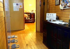 a room with a counter with pairs of shoes on the floor at Guest house Icyaribacyoude - Vacation STAY 09894v in Naha +1 photo