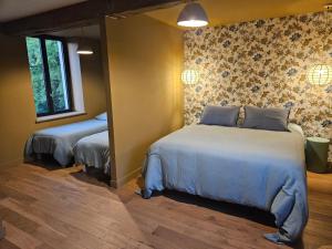 a bedroom with two beds in a room at La Maison des Chouettes in Maisons-lès-Chaource +20 photos