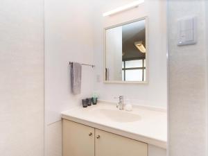 a bathroom with a sink and a mirror at El Sol Town OKINAWA - Vacation STAY 12494 in Chatan +28 photos