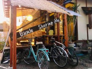 two bikes parked outside of a bicycle sharing shop at Kumamoto Farm Stay 2F - Vacation STAY 12481 in Takemiya