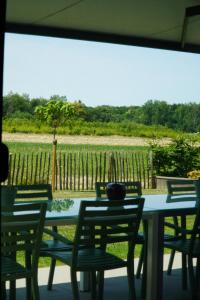 a table and chairs with a view of a field at Maison Toulouse in Affligem +36 photos