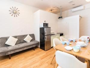 a living room with a couch and a table at El Sol Town OKINAWA - Vacation STAY 12496 in Chatan