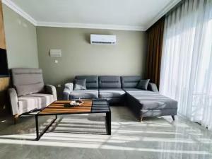 a living room with a couch and a coffee table at Royal Sun Elite Daire in Aglantzia