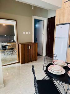 a dining room with a table and chairs and a kitchen at Royal Sun Elite Daire in Aglantzia