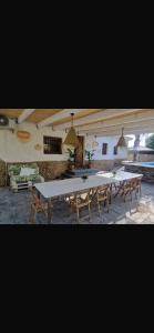 a large white table and benches in a room at Villas de encanto in Vilamarxant
