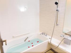 a bathroom with a bath tub with a shower at El Sol Town OKINAWA - Vacation STAY 12495 in Chatan +40 photos