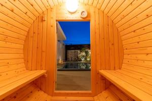 a wooden sauna with a mirror and a window at プライベートプールヴィラ天羽 in Nakijin +46 photos