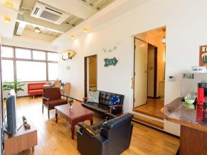 a living room with a couch and a table at El Sol Town OKINAWA - Vacation STAY 12495 in Chatan