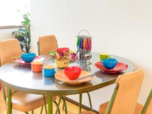 a table with colorful bowls and plates on it at El Sol Town OKINAWA - Vacation STAY 12495 in Chatan