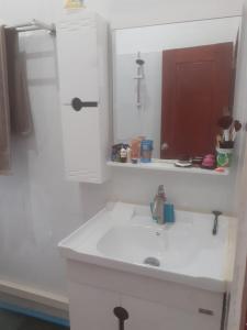 un bagno con lavandino e specchio di Maison neuve et moderne à Vientiane 