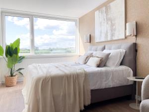 a bedroom with a bed with white sheets and a window at New Bed-room, Nature Location,university Tilburg in Tilburg
