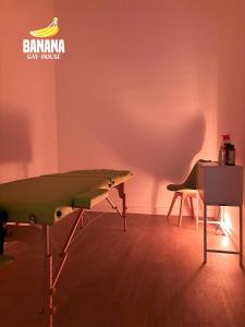 a room with a table and a chair in front of a wall at Banana Gay House - Only Men in Seville