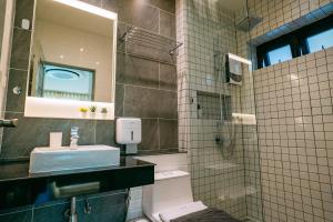 a bathroom with a sink and a shower with a mirror at Tabebuia House ทาเบบูย่าเฮ้าส์ in Pathiu +74 photos