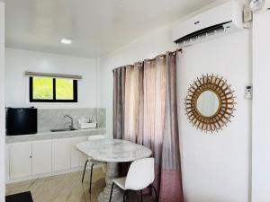 a kitchen with a table and a mirror on the wall at A & L Resort - Sea & Mountain View in Looc +186 photos
