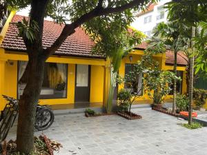een geel huis met een fiets voor het huis bij Tam Coc Mango Homestay - Free Swimming Pool in Ninh Binh