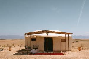 a tent in the middle of the desert at Caravansérail Agafay by Dar Inacamp in El Mjed