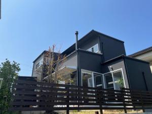 a black house with a fence in front of it at Minshuku Kakutani Hitohira - Vacation STAY 16023v in Wada