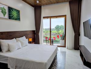 a bedroom with a bed and a large window at Daisy's Villa TamCoc in Vũ Lâm +47 photos