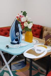a table with a vase of flowers on top of it at 45GR Dreams Unlimited Contractor Home in Harrow in Harrow