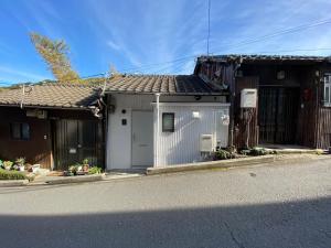 a house with a white garage on a street at Nagasaki Sakayado Hitoma - Vacation STAY 16332v in Nagasaki
