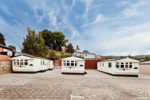 a group of white buildings in a parking lot at Villa Hexengericht in Thale