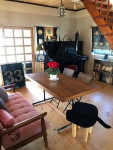 a living room with a wooden table and a piano at Woman Only Ohenro House33 - Vacation STAY 27239v in Kochi