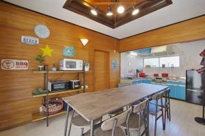 a kitchen with a table and chairs in a room at VILLENT KUJUKURI ARROW - Vacation STAY 32961v in Kujukuri
