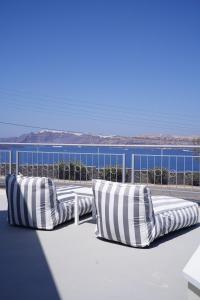 a row of pillows sitting on top of a roof at Akron Ariston Suites in Akrotiri +55 photos