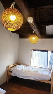 a bedroom with two chandeliers and a bed at base sanablend - Vacation STAY 04857v in Kyotango