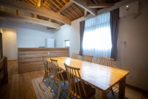 a dining room with a wooden table and chairs at Villa Muse Okinawa- Vacation STAY 43827v in Nago