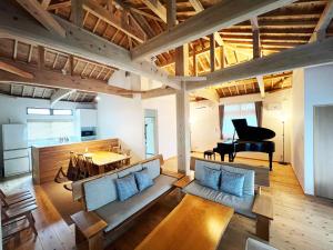 a living room with a couch and a piano at The Villa with a YAMAHA C6X - Villa Muse Okinawa- Vacation STAY 43827v in Nago