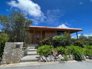 a house with stairs in front of it at The Villa with a YAMAHA C6X - Villa Muse Okinawa- Vacation STAY 43827v in Nago
