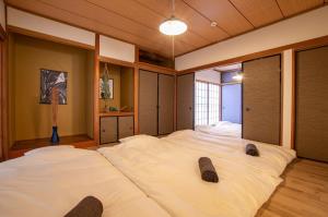 a bedroom with two large white beds in it at VIILENT KUJUKURI Ocean1 - Vacation STAY 33286v in Kujukuri