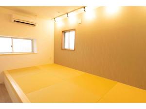 a room with a yellow floor and a window at Stardust Motobu - Vacation STAY 45756v in Motobu +26 photos