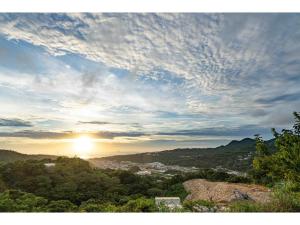a view of the sun setting over a city at Stardust Motobu - Vacation STAY 45756v in Motobu