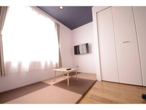 a room with a table and a large window at HOTEL APT SESELA - Vacation STAY 12878 in Kanazawa +6 photos
