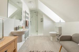 a bathroom with a sink toilet and a shower at Cartref - Saundersfoot in Saundersfoot +32 photos